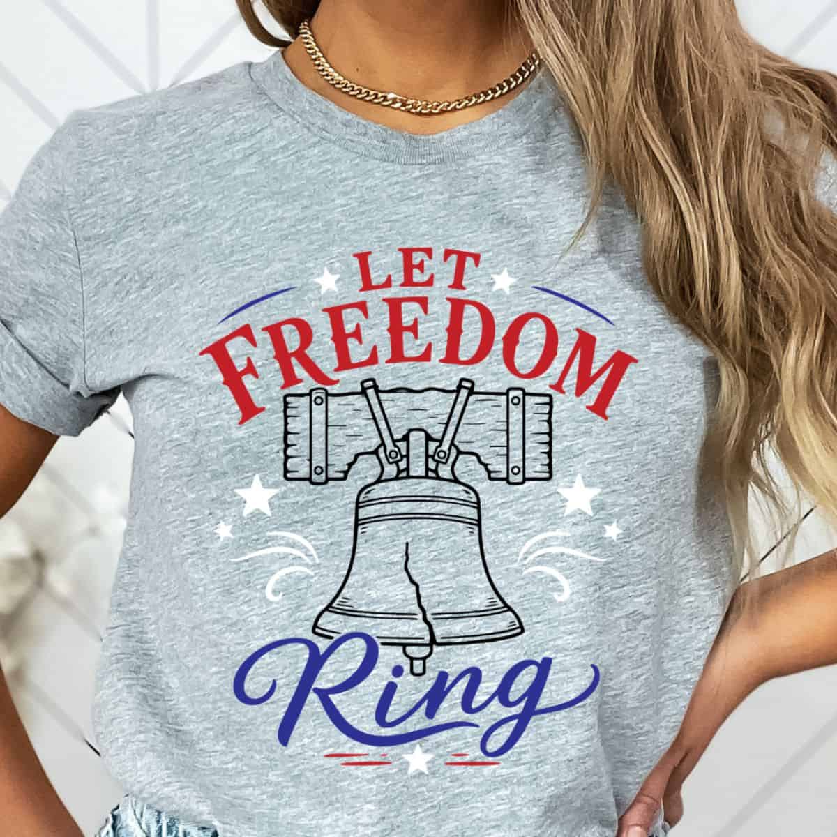 Woman wearing a gray Let Freedom Ring patriotic T-shirt featuring a Liberty Bell graphic with red, white, and blue lettering.
