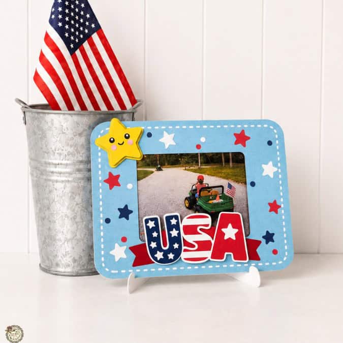 Patriotic USA photo frame with stars and stripes design displayed beside an American flag in a metal bucket.
