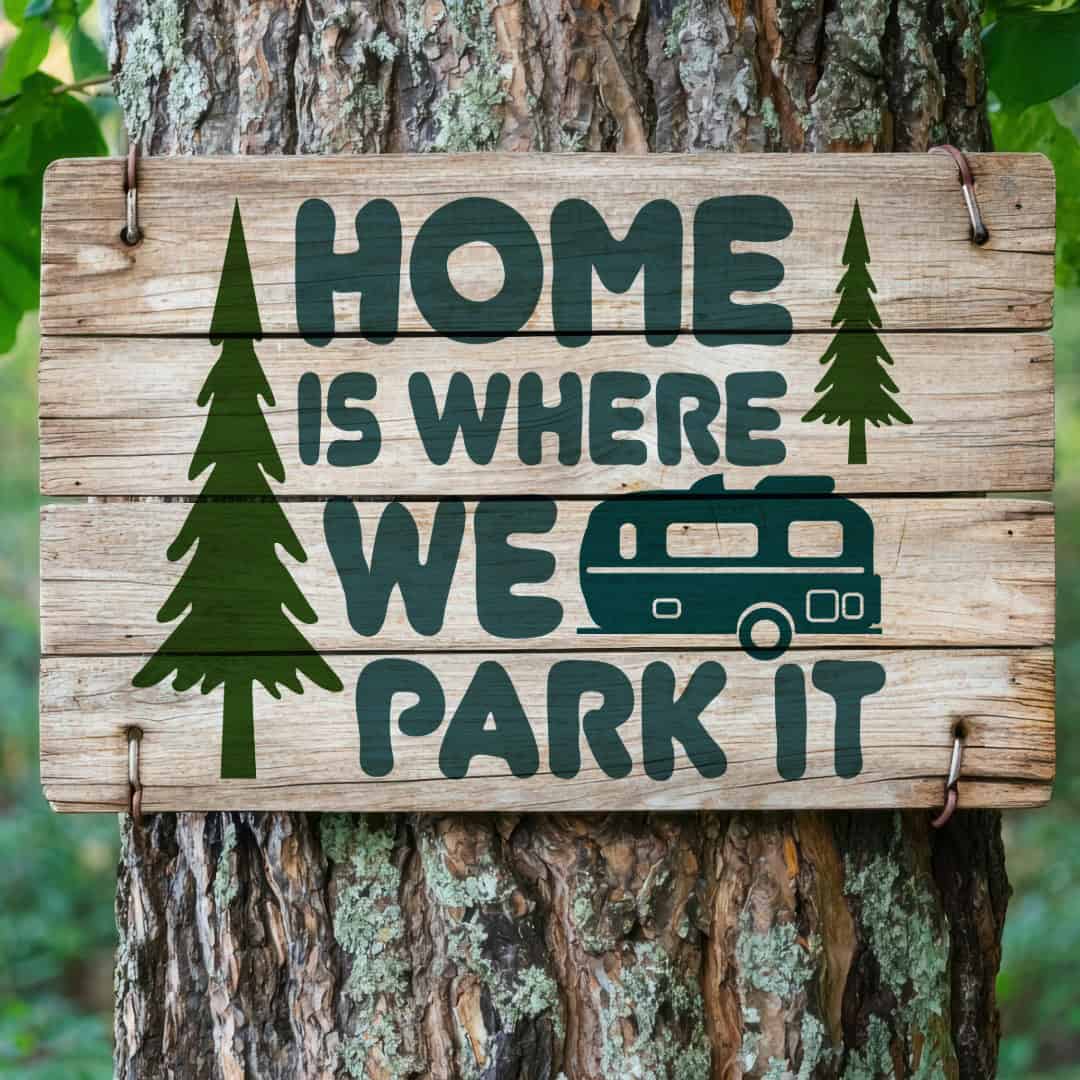 Wooden sign attached to a tree with the phrase