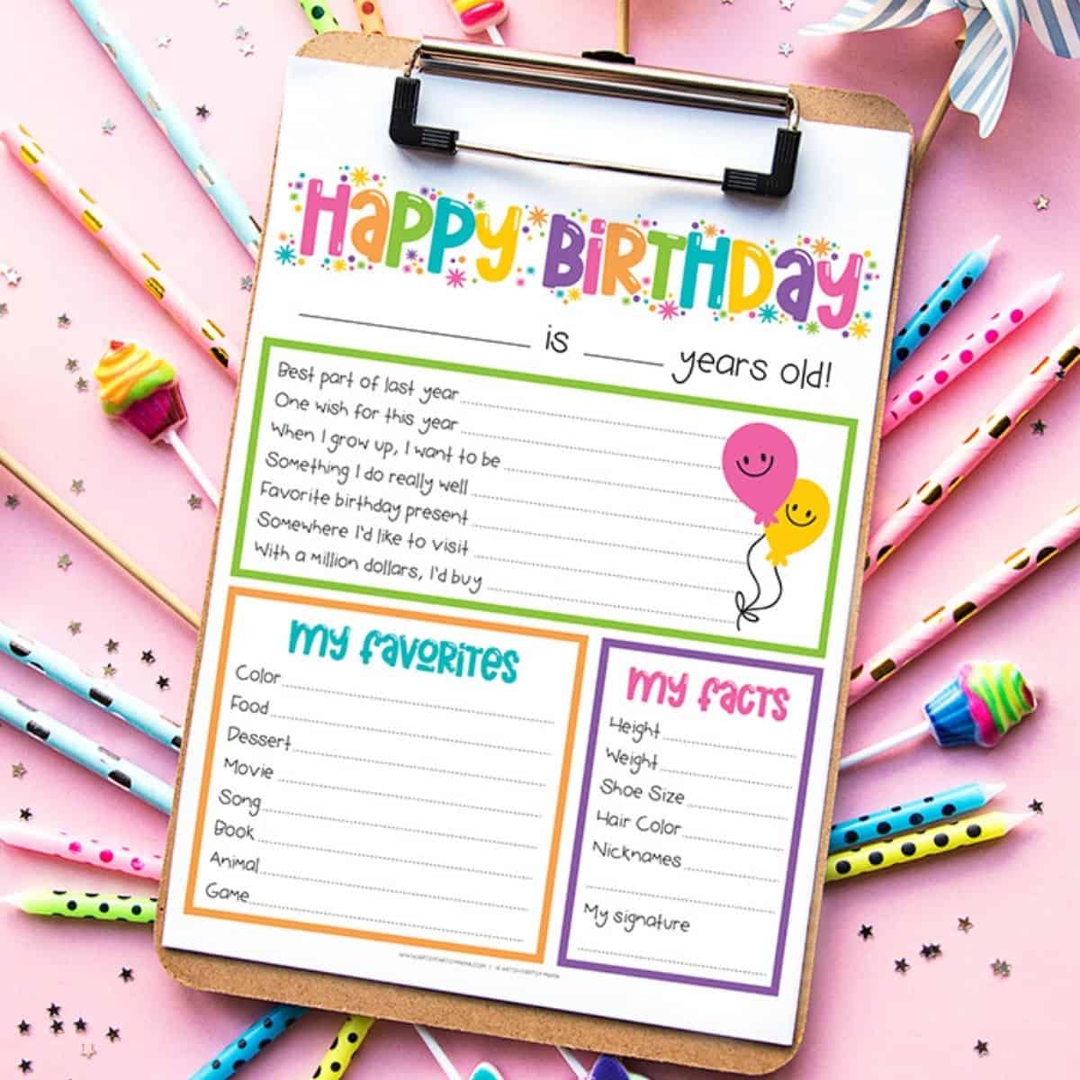 Birthday interview worksheet on a clipboard with colorful pencils and candy, featuring spaces for favorites, fun facts, birthday memories, and goals.