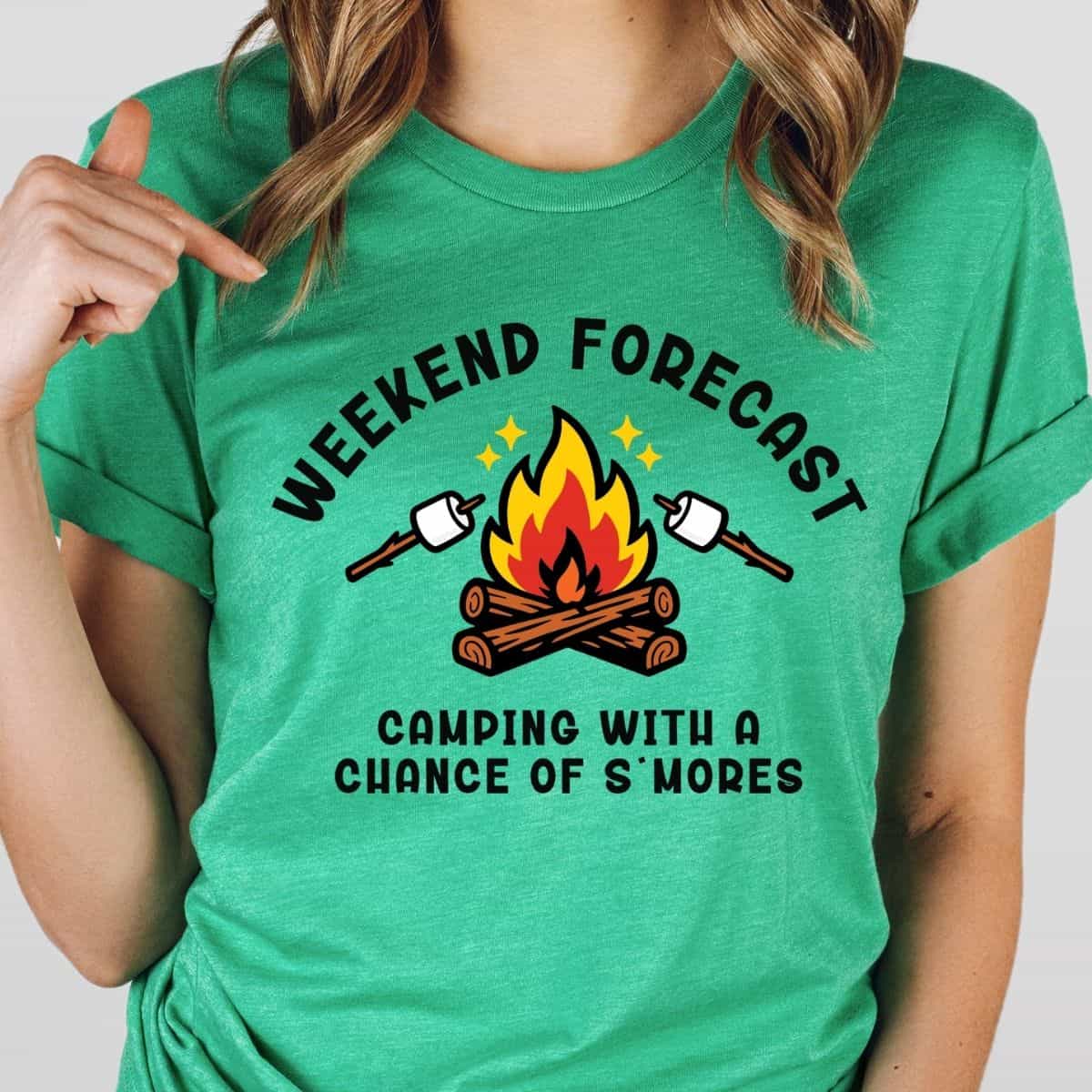 Green T-shirt with a campfire and marshmallow graphic featuring the phrase