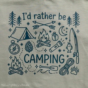 Camping-themed shirt design featuring the phrase “I’d rather be camping” with a tent, campfires, trees, fishing rod, flashlight, compass, and rope.
