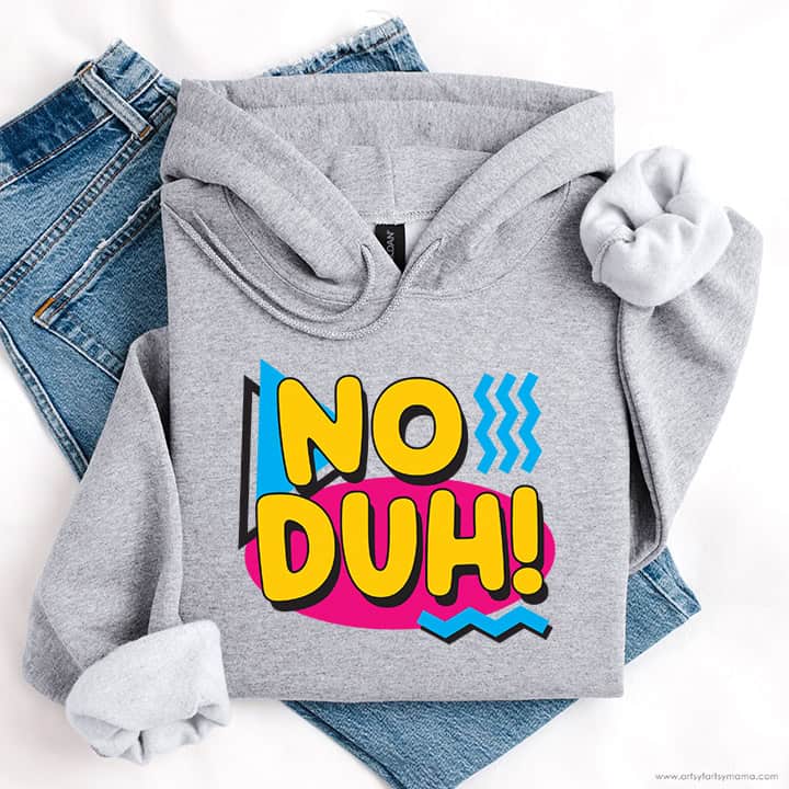 Gray hoodie with a colorful retro No Duh! graphic displayed over a pair of blue jeans.