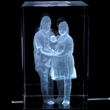 3D inner laser engraving of a family holding a baby inside a clear crystal block, created with the xTool F2 Ultra laser engraver.