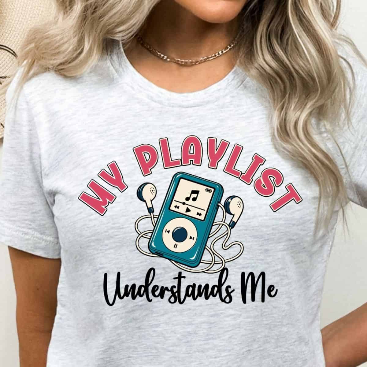 Light gray T-shirt featuring a retro music player with earbuds and the phrase "My Playlist Understands Me" in pink and black lettering.