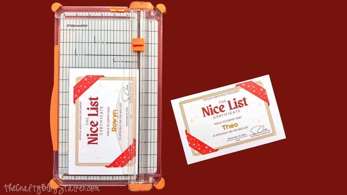 Fiskars paper trimmer holding a personalized Official Nice List Certificate for Rowyn, with a finished certificate for Theo beside it.