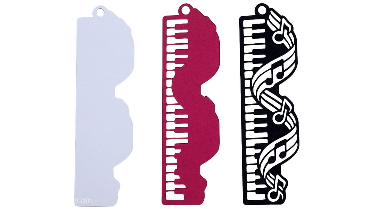 Three cardstock layers for a DIY piano bookmark, featuring a white backing, pink keyboard layer, and black musical note design.