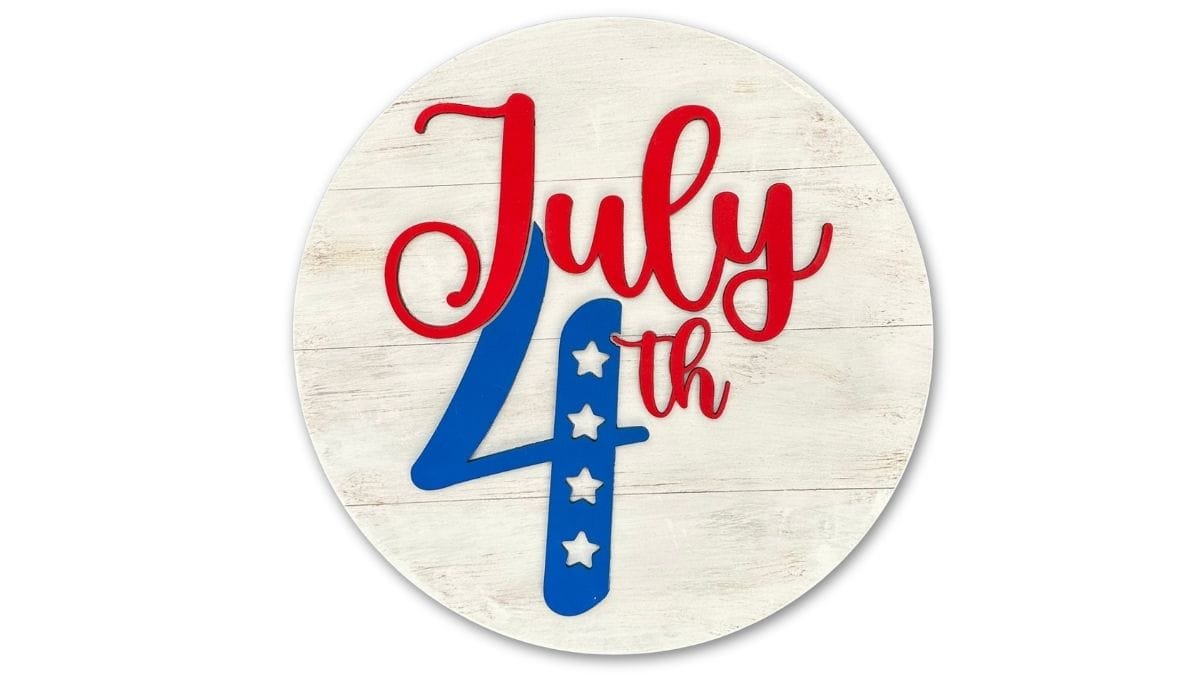 Round farmhouse-style July 4th sign with red script lettering and a blue number four decorated with white stars.