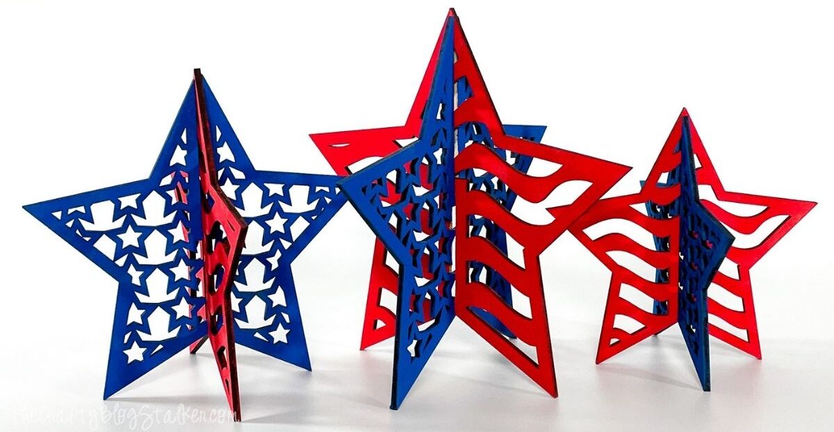 Three freestanding 3D patriotic star decorations in red and blue, featuring cutout stars and American flag-inspired designs on a white background.