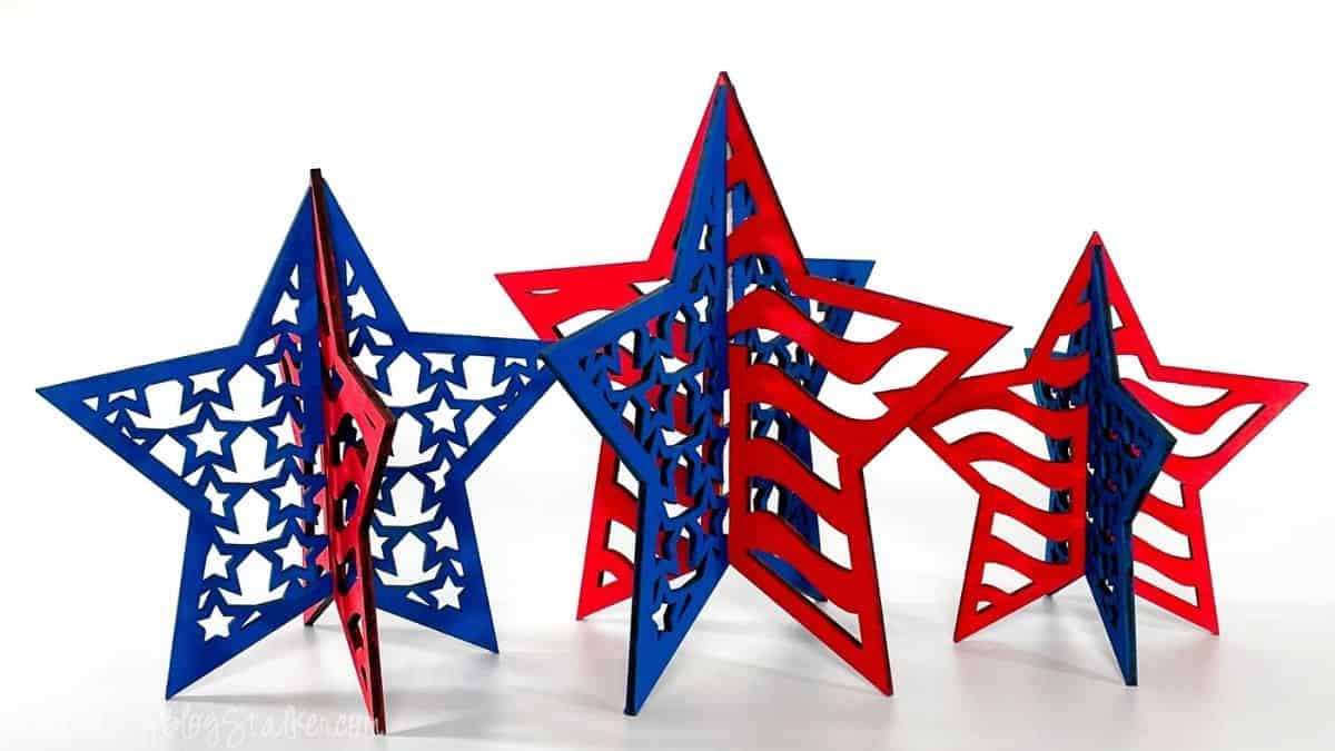 Three freestanding 3D patriotic star decorations in red and blue, featuring cutout stars and American flag-inspired designs on a white background.
