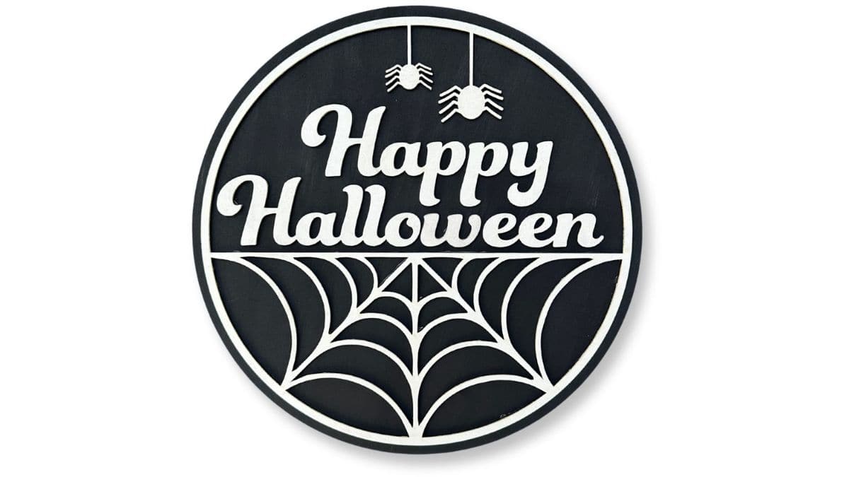 Round black and white Halloween door hanger with the words "Happy Halloween," a spiderweb design, and two hanging spiders at the top.