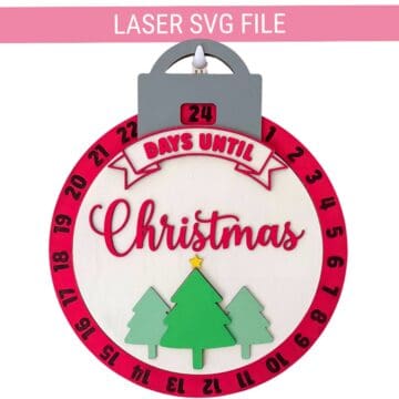Round laser cut Christmas countdown ornament SVG with numbered day wheel, layered evergreen trees, and a sliding Days Until Christmas display.