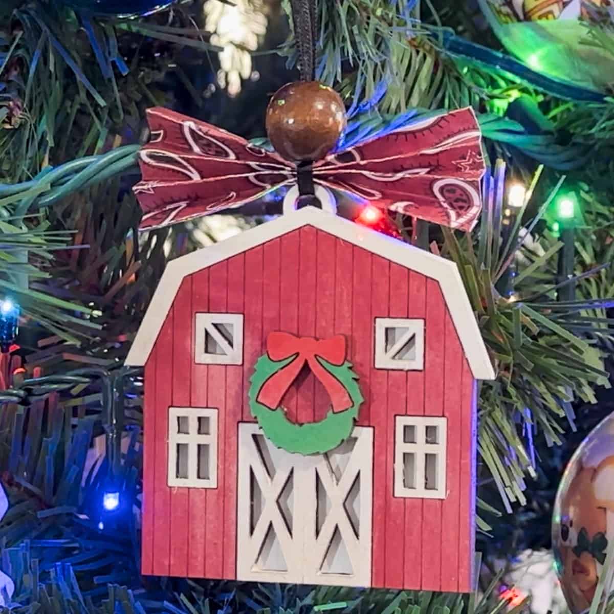 Old Barn Christmas Ornament hanging on a tree.