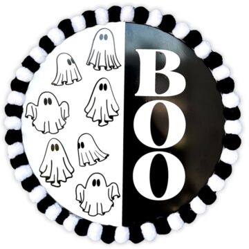 Black and white Halloween door hanger with "BOO" text on one side and hand-drawn ghosts on the other, bordered with alternating black and white pom-poms.