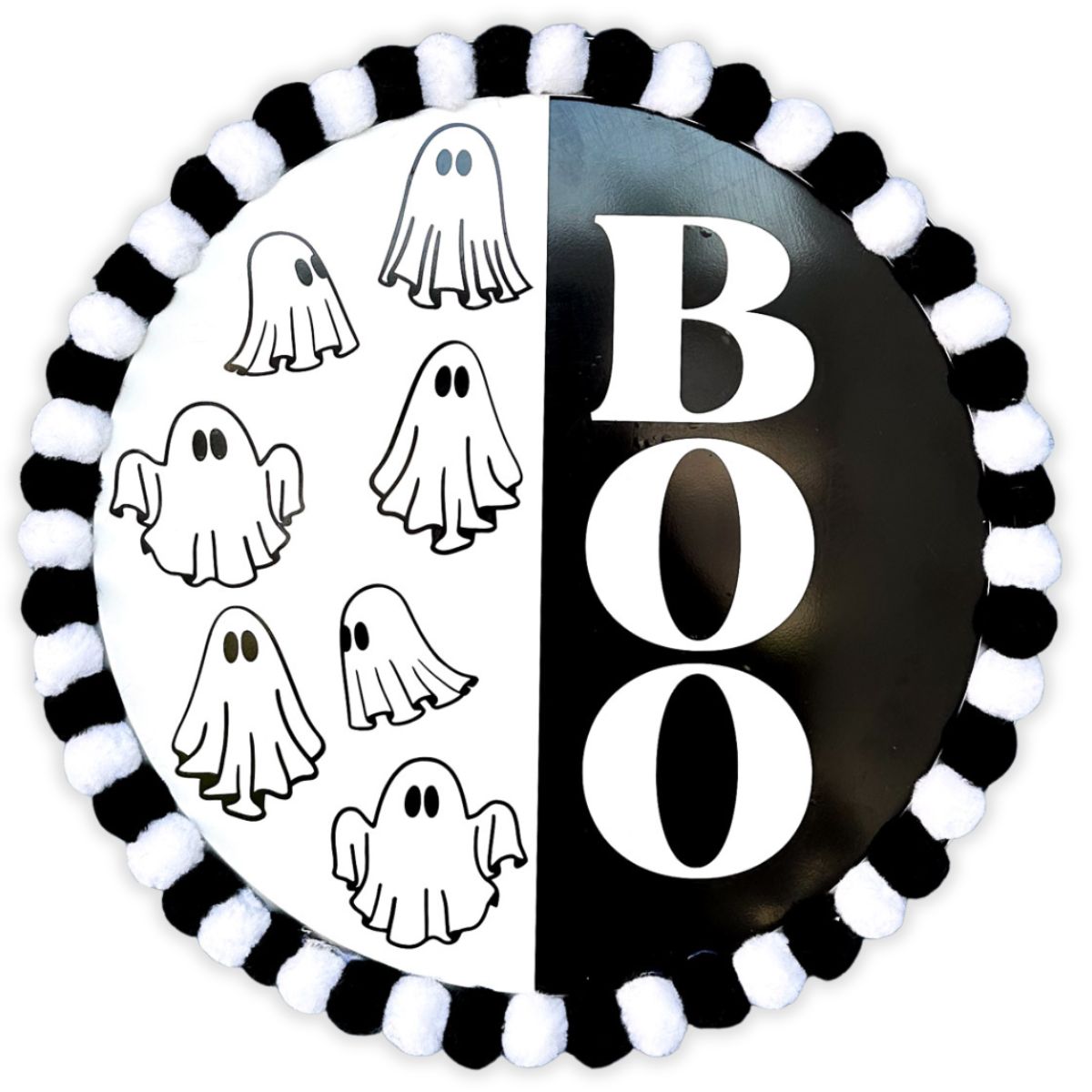 Black and white Halloween door hanger with "BOO" text on one side and hand-drawn ghosts on the other, bordered with alternating black and white pom-poms.