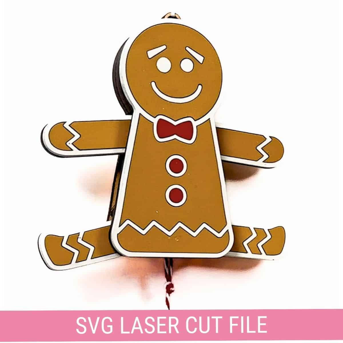 Festive gingerbread man pull-string ornament with a red bowtie and buttons, crafted using a laser cut SVG file. Perfect for DIY holiday decor and Christmas crafts.