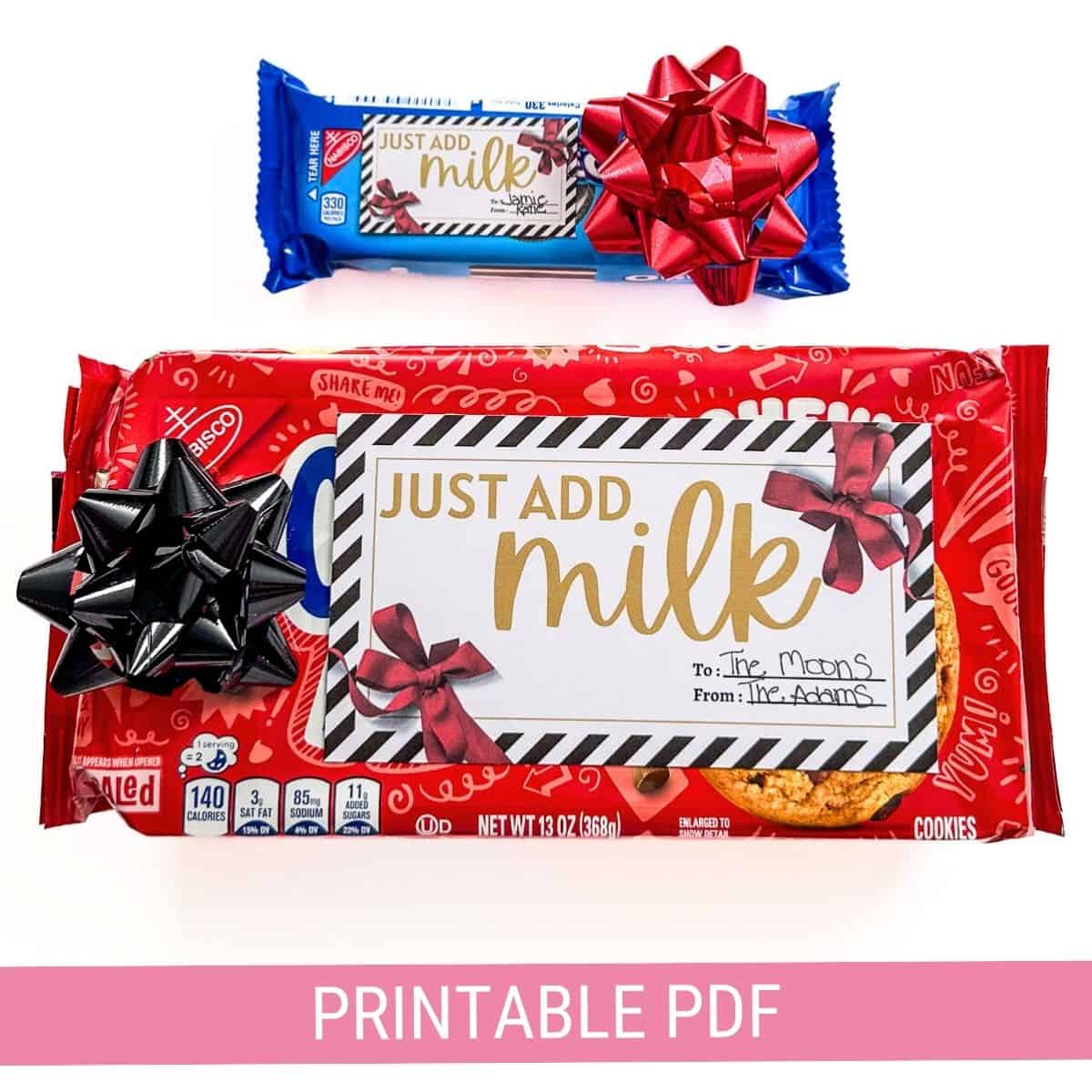 Two cookie packages, one red with a black bow and one blue with a red bow, feature gift tags reading "Just Add Milk." A pink banner says "Printable PDF."