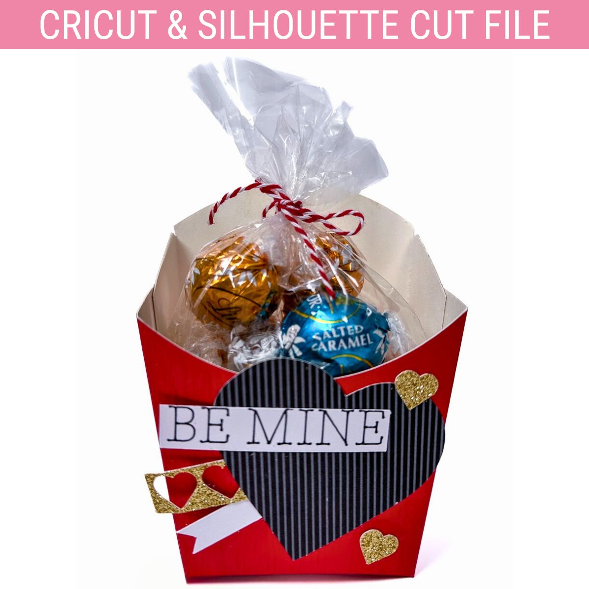 Valentine’s fry box treat holder in red with “Be Mine” text, a black striped heart, and gold glitter hearts, filled with wrapped Lindor truffles in a gift bag.
