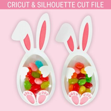 Two Easter bunny treat holders shaped like eggs with ears, paws, and feet, filled with colorful jelly beans, made from a Cricut and Silhouette cut file.