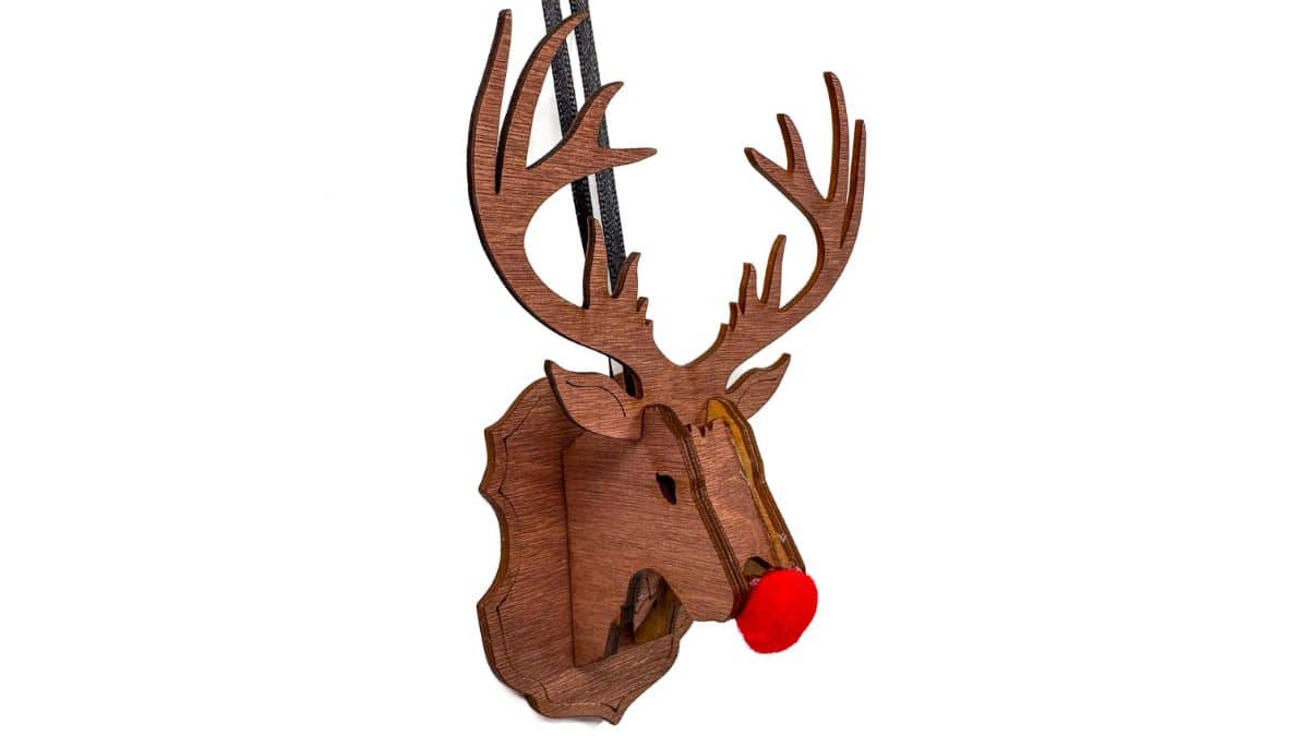 Wooden reindeer ornament with layered antlers and a bright red pom-pom nose hanging from a black cord.