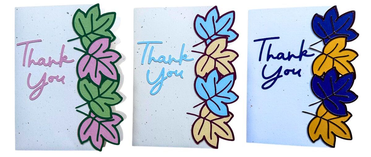 Three handmade thank you cards displayed side by side, each featuring a leaf border design and handwritten “thank you” lettering in different seasonal styles.