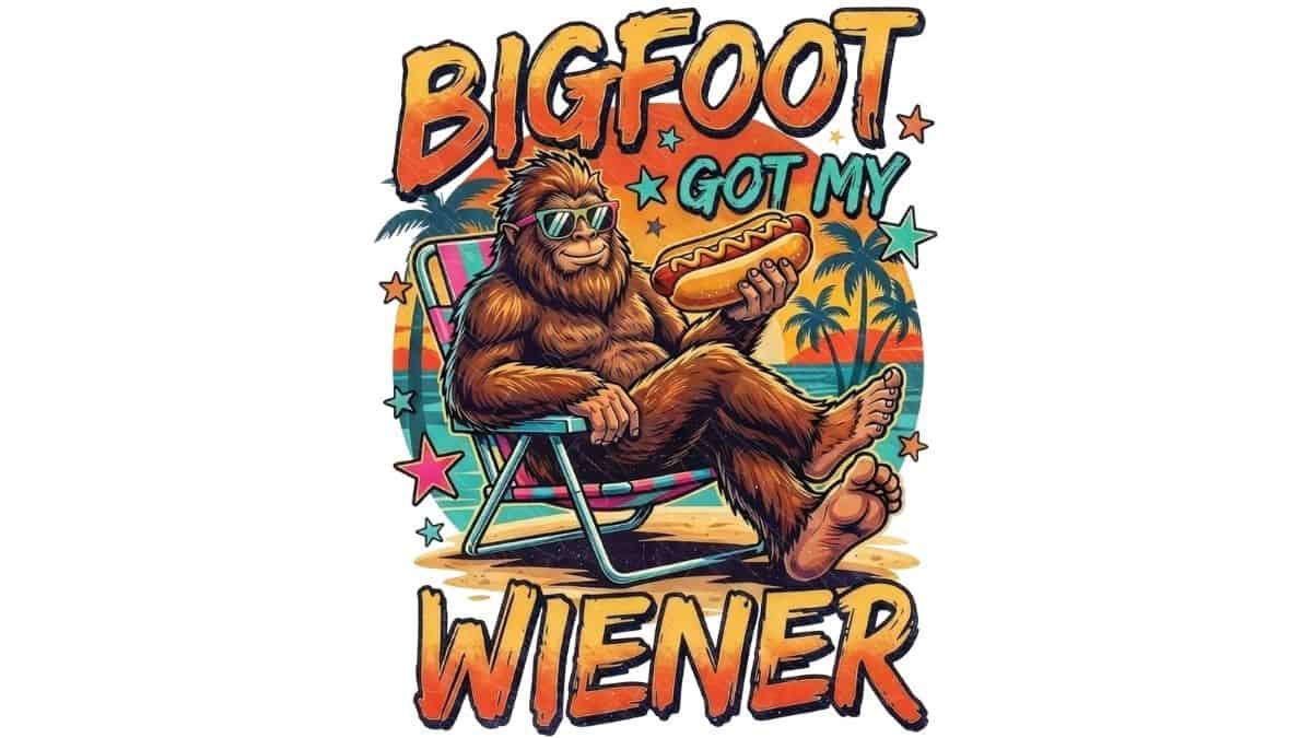 Bigfoot wearing sunglasses and relaxing in a beach chair while holding a hot dog, with the colorful phrase "Bigfoot Got My Wiener" in a retro PNG design.