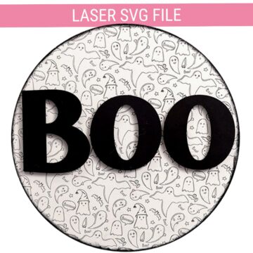 Round Halloween door hanger with a ghost pattern background and large black BOO letters, shown as a laser SVG file design.